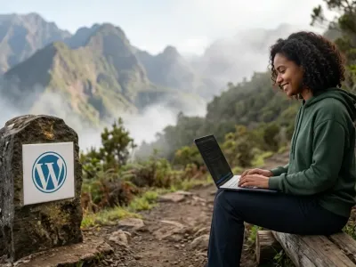 Développeuse codant des conditional tags WordPress sur ordinateur près d'une borne balisée en pleine montagne.
